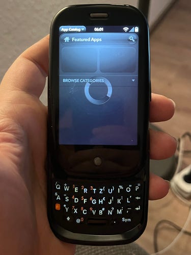 Palm Pre with the hardware keyboard expanded, trying in vain to contact the long closed down App Catalog