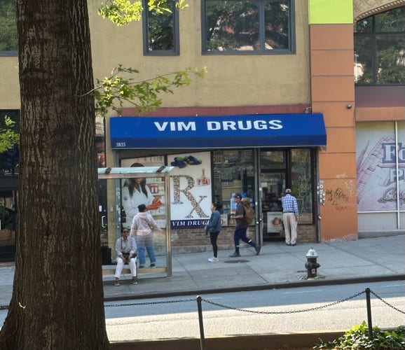 a pic of medicine store that reads "VIM DRUGS" 