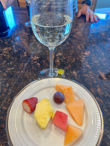 Glass of Prosecco and plate with fruit