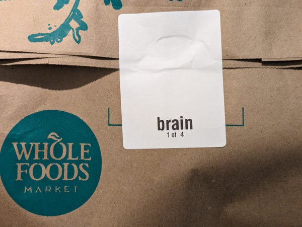 Whole foods grocery bag with printed label for "brain - 1 of 4"