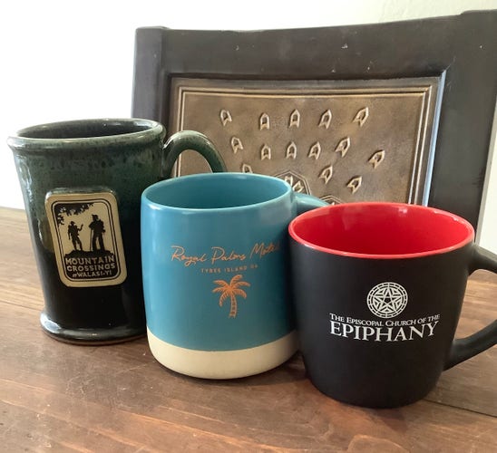Three coffee cups: Mountain Crossings, Royal Palms Motel on Tybee Island, and the Episcopal Church