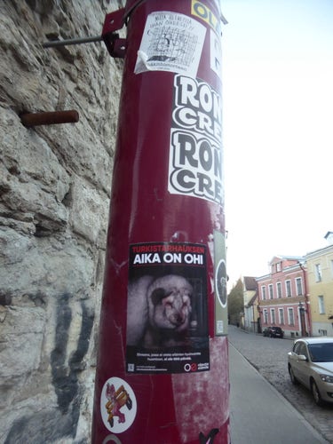 Animal rights stickers on pole at Uus/Aia corner in Tallinn.

A sticker "lazy bottom wolf pup" with a social media handle is also visible (artwork attributed to  therealdafwe/Howie the Collie).