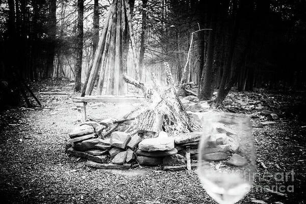 B&W photo of a bonfire in the woods to start the spring season
