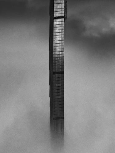 A NYC skyscraper upside down. In clouds. B&amp;w.