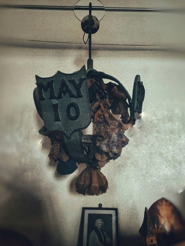 The faded maiden garland. You can prominently see the May 10 date on its metal hanging
