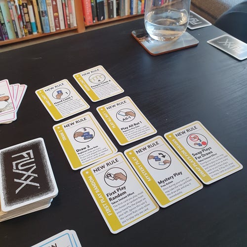 The "rules" part of the game FLUXX on the table. There are 7 new rules overriding all kinds of basic rules. The game is clearly complex and chaotic. 