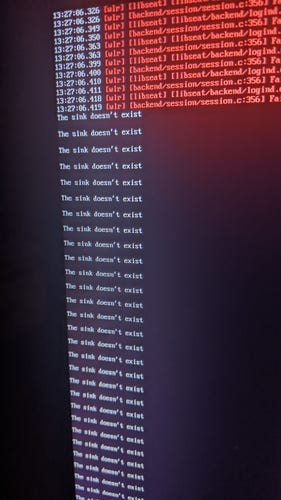 A photo of a system update showing some opaque errors in red, then it starts repeating nonstop: "The sink doesn't exist the sink doesn't exist the sink doesn't exist the sink doesn't exist the sink...."