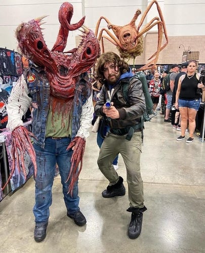 The Thing Cosplay, with two dudes, one cosplayed as MacReady with his flamethrower, and Norris' spider-head, and the other cosplayed as not-the-real-Palmer