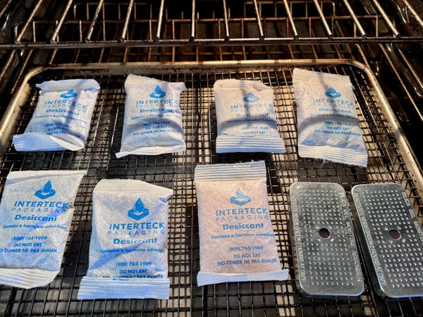 desicant packs on a tray going into the oven