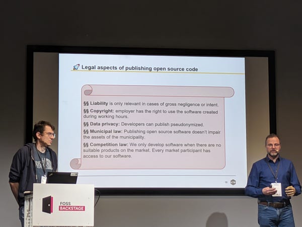 Picture of Klaus Müller and Dirk Gernhardt from City of Munich, and a slide with legal considerations of publishing open source