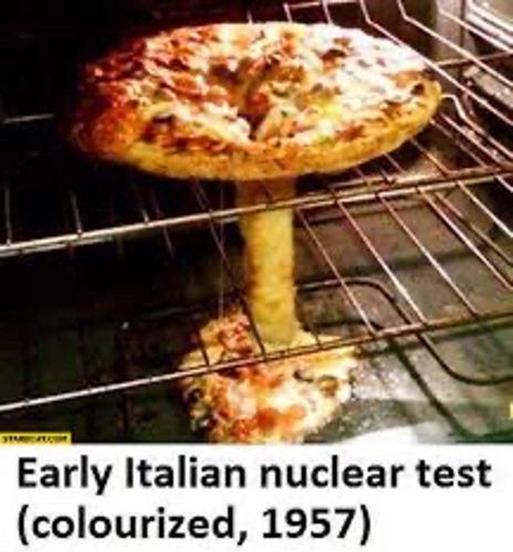 A pizza in an oven. The center sank through the rack and continued to bake on the base plate. The whole pizza now resembles a mushroom like in a nuclear detonation.