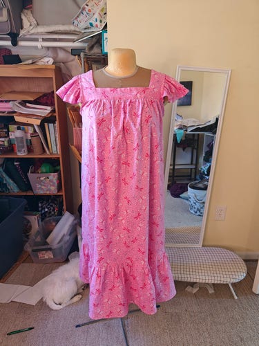 A pink nightgown sits on a dressmaker's mannequin 