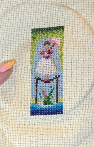 Tightrope walker haunted mansion mini cross stitch with thing for size (is smol!)