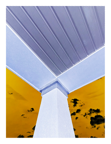 inverted and recolored. the view from under the canopy over a shoe store at the end of an old strip mall. 