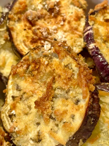 Large slices of crispy eggplant coated with egg, panko crumbs, flour, seasonings and Parmesan cheese and then drizzled with olive oil. 