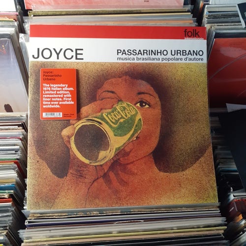 Album cover features a painting of a woman wearing a large brimmed hat, drinking a can of Coca Cola, only the Coke can is green. Maybe that was a thing in Brazil?