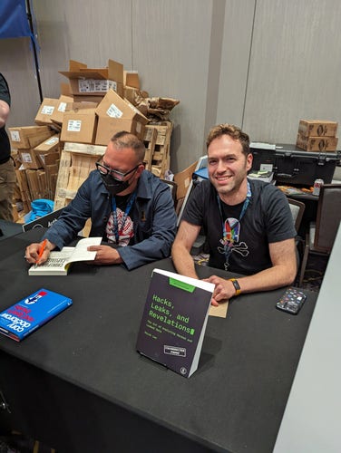 Me and Micah Lee, signing at the No Starch Press booth at Defcon. Photo by Bill Pollock.