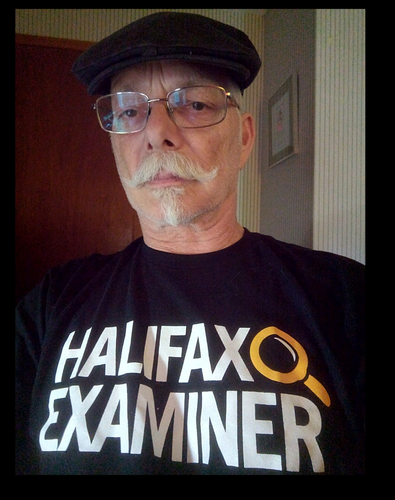 A selfie. Man with a black hat, glasses, white moustache and goatee, wearing a  black shirt with bright contrasting white bold text HALIFAX EXAMINER and a Magnifying glass in Yellow at the end of Halifax, symbolizing the depth of their investigative reporting. 

DISCLAIMER - I am in now way affiliated with this newspaper and receive no credit for promoting them. I do so of my own free will with the conviction that you need to know where good news can be found. 
HERE IT IS! While mostly of Maritime Interest, INVESTIGATIVE REPORTING really appeals to me. I'm less interested in Fillers in local news sources. 