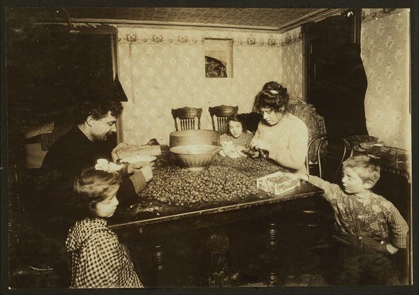  The image captures a nostalgic scene from the early 20th century. A family is gathered around a table, engrossed in sorting nuts. The room they're in is warmly lit, with a homely feel to it. The father and mother are assisting their children in this activity, indicating a sense of unity and shared responsibility within the family unit.

In one corner of the image, there's an old-fashioned cobbler's shop, hinting at the diverse interests of the family members or perhaps even the means by which they earn their living. The presence of handkerchiefs on the table might suggest that the photo was taken during a time when colds were common and hygiene practices were not as strict as they are today.

The atmosphere is one of familial warmth and togetherness, set against the backdrop of everyday life in New York state in that era. The image paints a vivid picture of family life during a time when simplicity was valued and community played a more significant role in day-to-day existence.