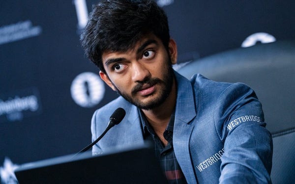 Photo of Gukesh sitting in front of the microphone at the press conference (Credits: FIDE / Maria Emelianova)