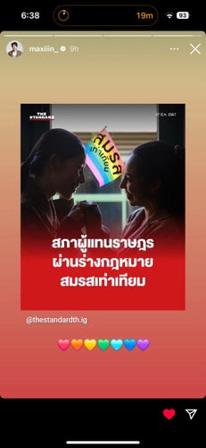 A screenshot of Max Nattapol’s (handle: @maxiiin_ ) insta story featuring two women facing each other with their hands clasped, smiling. There's a pride flag in the background, and Thai text overlay which says “สภาผู้แทนราษฎร ผ่านร่างกฎหมาย สมรสเท่าเทียม” which translates to: “The House of Representatives passed the equal marriage bill.” Under that is Max’s addition: a rainbow of emoji hearts.
