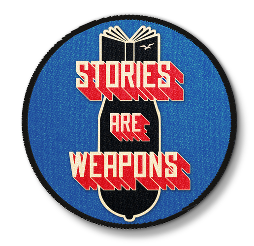 A blue, circular patch with red-and-white 3-D letters that read "Stories are weapons." Behind the letters is a black old-fashioned bomb whose fins are made of a book with its pages fanned out.