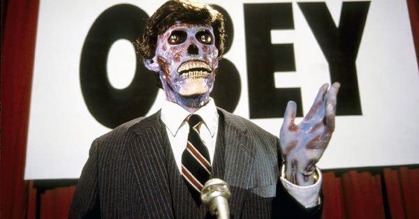 A frame from the movie They Live of a zombified alien politician standing in front of an obey sign