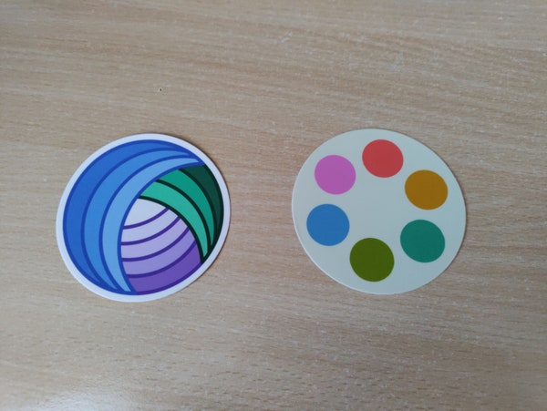 Two stickers: one of the Polymaths.social logo, and one of the Clew.se search engine!