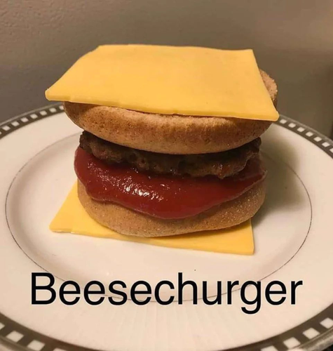 Cursed image of a cheeseburger, where the cheese is the outermost layer and then comes the bun and then the meat with lots of ketchup.