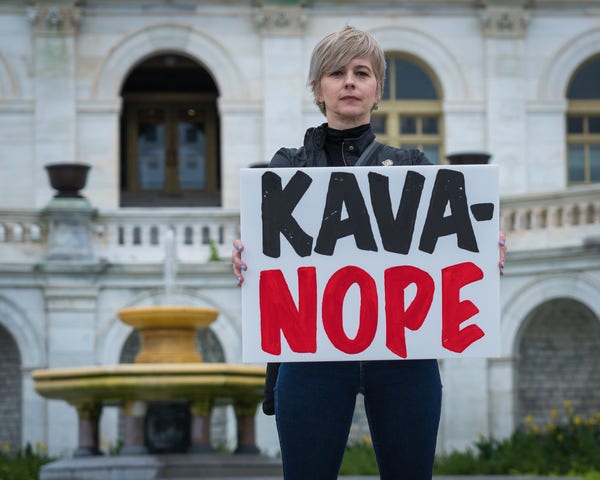 Protestor holds sign, Kava-Nope.