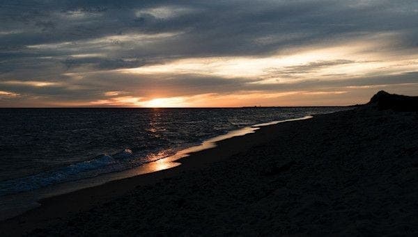 High contrast dramatic view of Cape Cod's Herring Cove Beach as darkness falls