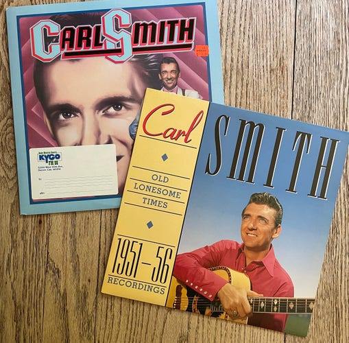 Color photo of two Carl Smith compilation LPs. 