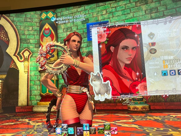 Photo of my computer screen showing the game Final Fantasy XIV running. My female character "Fang Striker" is on the screen and dressed in all red with red hair.