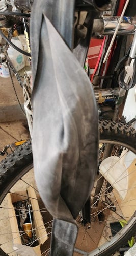 Bicycle inner tube with a 280mm (11 in.) split. I hung it on handlebars and turned inside out for the photo.