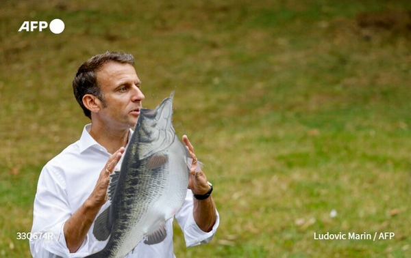 Emmanuel Macron holding a fish