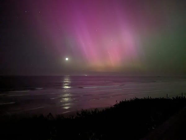 Misty aurora, with the moon reflected in the ocean.