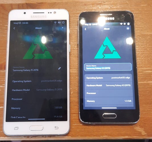 A Samsung Galaxy J5 from 2016 and a Samsung Galaxy A3 from 2015 lying next to each other on a table. Both are running postmarketOS with GNOME Mobile Shell and are showing the about page in the GNOME Settings app.