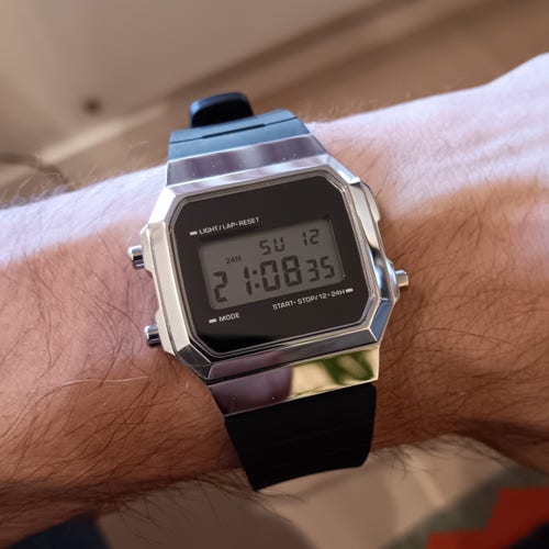 Skxmod of a Casio A168, with a very shiny silver tone case and a black rubber strap. 