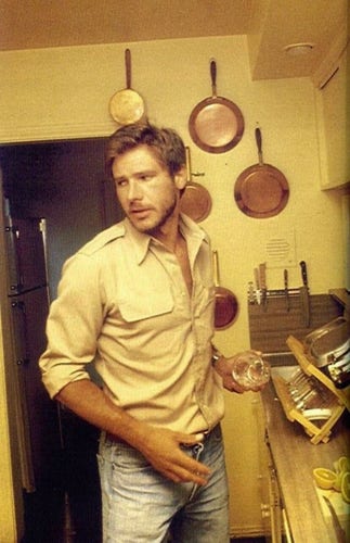 Harrison Ford in jeans and unbuttoned shirt in the kitchen