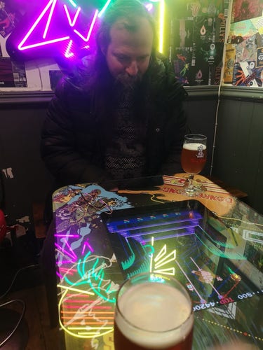 Giles playing donkey Kong 3 on the cocktail cab