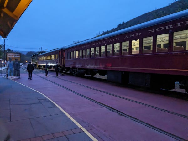 Dawn at the Jim Thorpe train station. Diesel locomotive and two passenger coaches in view.
