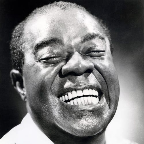 b/w pic of Louis Armstrong with closed eyes and a huge grin