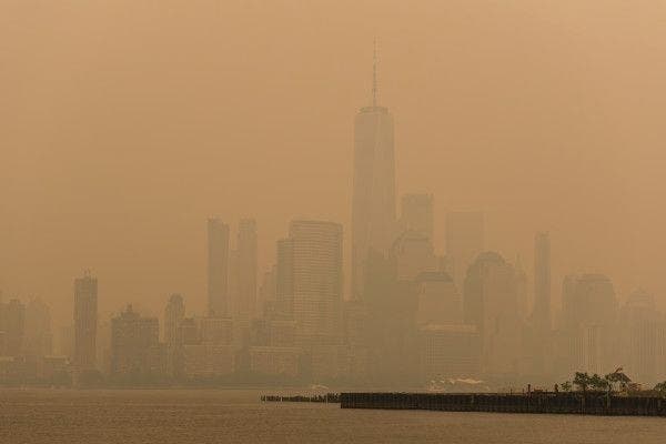 NYC Lower Manhattan Skyline shrouded in smoky haze from Summer 2023 Canadian Wildfires, a record-breaking Air Quality Index of nearly 500