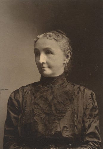 Augusta Jane Evans Wilson (1835-1909), American novelist c.1890.

Sepia portrait of Augusta Jane Evans Wilson with her face turned slightly to the left, her gray hair tied back in a bun and wearing pearl earrings. Formal dress with floral arrangements on a dark brown background and a high collar.