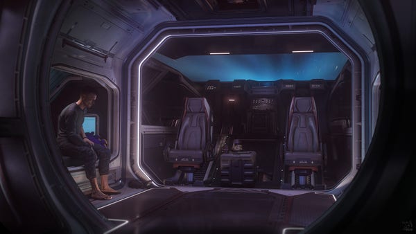 Star Citizen in-game screenshot of a man sitting on the bed in the Crusader C1 Spirit while in quantum travel.