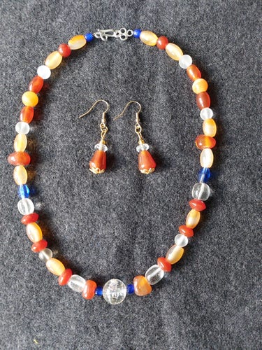 a  necklace and earring set made from semi precious stones ( agate, carnelian, quartz) and glass
