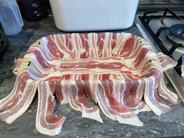 Oven dish lined with streaky bacon