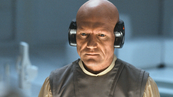 Lobot from Empire Strikes Back, a guy on Cloud City with a neural prothesis attached around the back of his head from ear to ear.