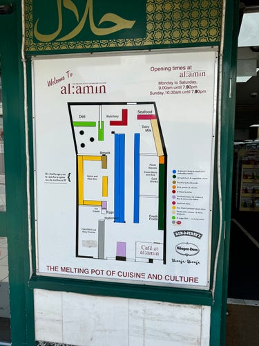 Map of “Al Amin” listing departments (deli, butchery, seafood, breads, fruits, eggs, etc). The “Spice and Rice Den” is annotated “We challenge you to ask for a spice we do not have !!!!”. There’s also a cafe, a post office, and logos for Ben & Jerry’s, Haagen-Dazs and Booja Booja ice cream