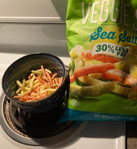 Photo of a bowl of “veggie fries” and next to it the bag they come from. The actual fries are at least 10x thinner than the ones on the packaging.